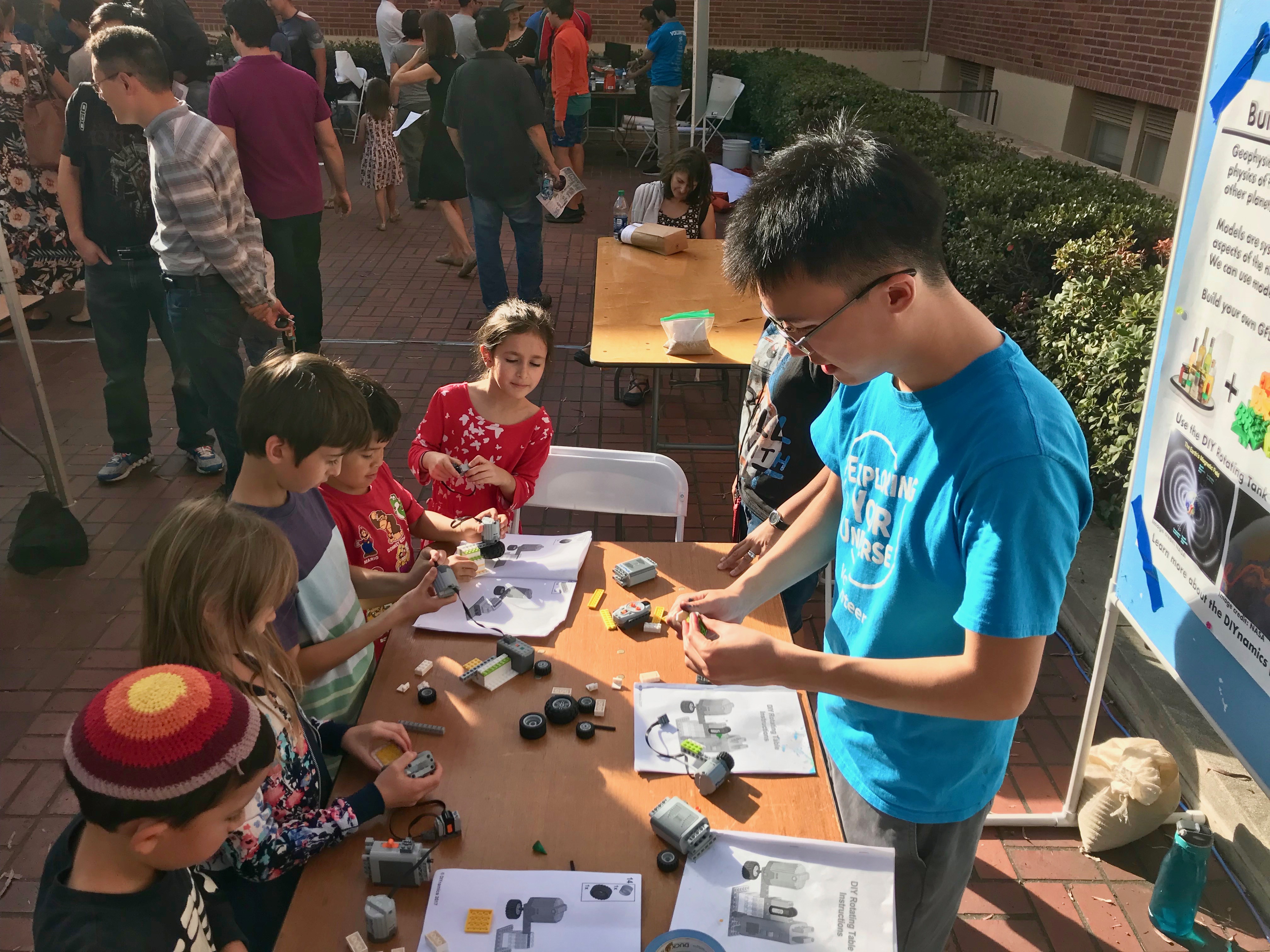 Norris helping visitors build their own motors